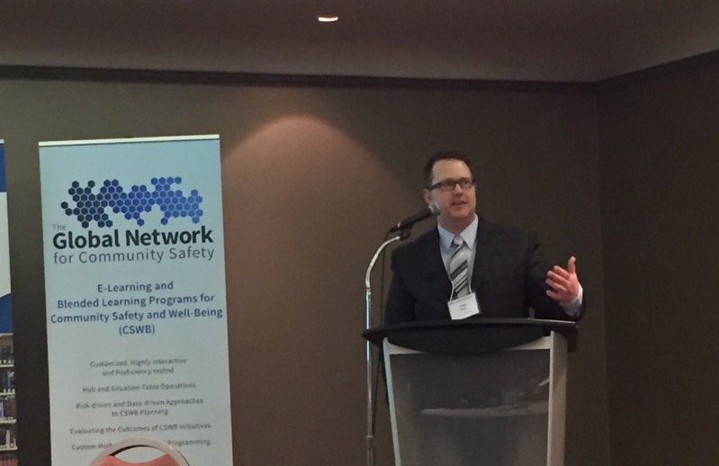 Dr. Chad Nilson addresses delegates at a conference in Toronto.
